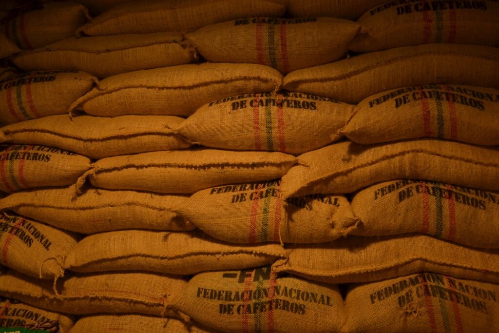 Rows of coffee bean sacks from Federación Nacional de Cafeteros in a Colombian warehouse